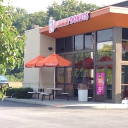 Dunkin' - The front of Dunkin Donuts with a small area to sit and eat outside.