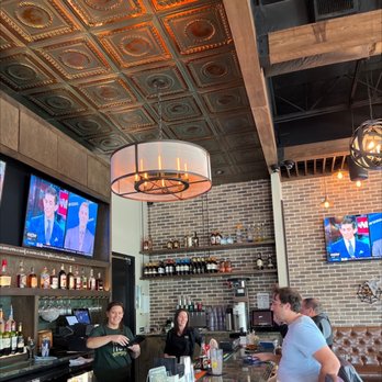 Irish 31 - people sitting at a bar watching tvs - Irish Near Me - Seminole, Florida
