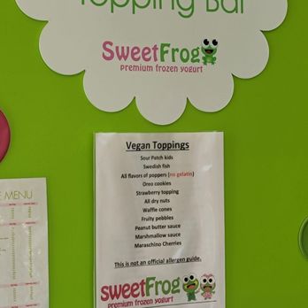 sweetFrog Premium Frozen Yogurt - a green wall with a sign that says jazz it up topping bar - Ice Cream & Frozen Yogurt Near Me - Cary, North Carolina