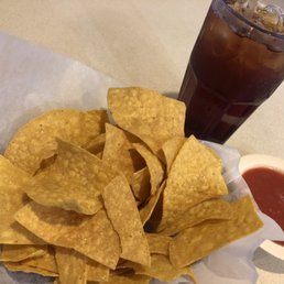 a plate of tortilla chips and a drink