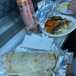 Burrito with a side of grilled onions and grilled hot peppers for those who dare to try.