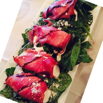Scuzzi's 1604 - "Wrapped Pancetta" It's actually mozzarella wrapped with pancetta on a bed of spinach drizzled with a balsamic vinaigrette. - Italian Near Me - San Antonio, Texas Scuzzi's 1604 - "Wrapped Pancetta" It's actually mozzarella wrapped with pancetta on a bed of spinach drizzled with a balsamic vinaigrette. - Italian Near Me - San Antonio, Texas