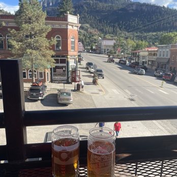 Ouray Brewery - Cold beer and downtown Ouray from the rooftop - New American Near Me - Ouray, Colorado