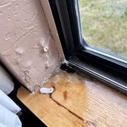 Pictured Rocks Inn & Suites - Water damage and holes in the window sill letting in Lord knows what.