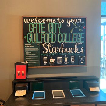 Starbucks - a coffee shop counter with a chalk board - Coffee & Tea Near Me - Greensboro, North Carolina Starbucks - a coffee shop counter with a chalk board - Coffee & Tea Near Me - Greensboro, North Carolina