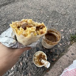 Tlaquesalsa veggie burrito featuring a foil spoon to scoop salsa onto the burrito. So good.
