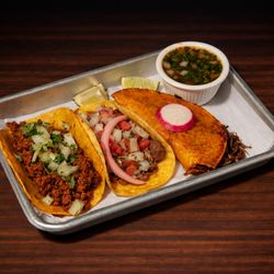 Mix of tacos. From left to right, Chorizo, Carnitas and Birria.