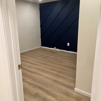 BJGE - Added overhead lighting, removed carpet and replaced with LVP, built and painted accent wall for our gym. - General Contractors Near Me - Reston, Virginia