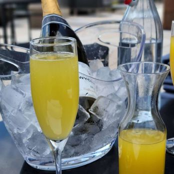 Perch SW Rooftop Lounge - a glass of orange juice and a bottle of champagne - Lounges Near Me - Washington, DC, District of Columbia Perch SW Rooftop Lounge - a glass of orange juice and a bottle of champagne - Lounges Near Me - Washington, DC, District of Columbia