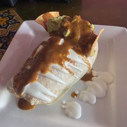 Birria burrito after adding hot sauce