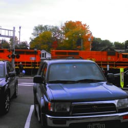 Essex Junction Amtrak Station - NECR 3015 a GP40-2CU (CU=Control Unit for the yard slug)and NECR 3809 a GP40CU leads NECR 500 Burlington electric wood chip train in Essex