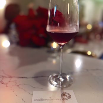 Native Bloom Winery - a glass of wine on a table - Wine Tasting Room Near Me - Ventura, California Native Bloom Winery - a glass of wine on a table - Wine Tasting Room Near Me - Ventura, California