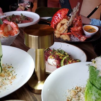 Palma - plates of food on a wooden table - Seafood Near Me - Montreal, Quebec Palma - plates of food on a wooden table - Seafood Near Me - Montreal, Quebec