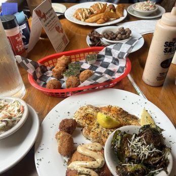 Hyman's Seafood - Salmon croquettes and Brussels sprouts and Cajun swordfish and Hush Puppy Basket - Seafood Near Me - Charleston, South Carolina