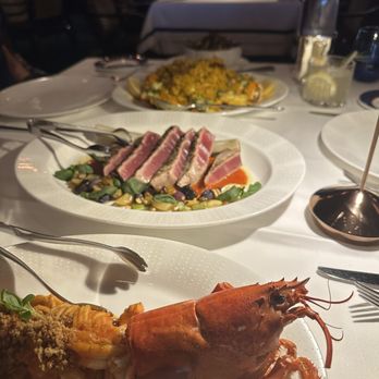PISCES - Front to back: Spicy Lobster Spaghetti, 12 oz. Grilled Bluefin Tuna "Chop", and Paella - Mediterranean Near Me - Las Vegas, Nevada