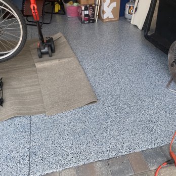 Garage Living - a bicycle and a fan in a garage - Flooring Near Me - Jacksonville, Florida Garage Living - a bicycle and a fan in a garage - Flooring Near Me - Jacksonville, Florida