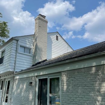 RJ Remodeling - a white brick house with a chimney - Flooring Near Me RJ Remodeling - a white brick house with a chimney - Flooring Near Me