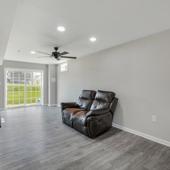 Sam's Remodeling - a living room with a leather recliner - General Contractors Near Me