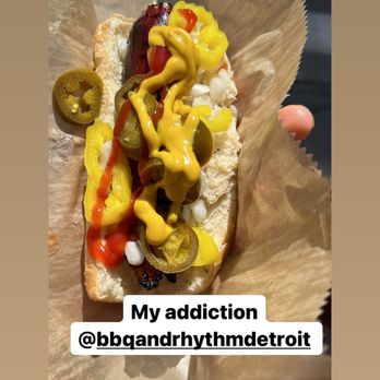 Red Tent Bbq And Rhythm - a person holding a hot dog - Food Trucks Near Me Red Tent Bbq And Rhythm - a person holding a hot dog - Food Trucks Near Me