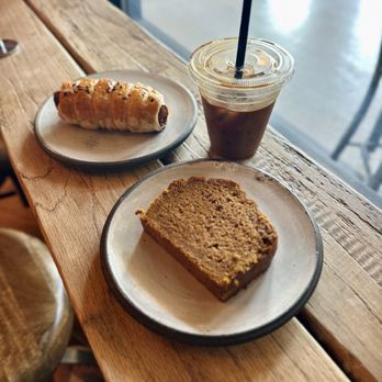 West Oak Coffee Bar - Spicy Sausage Roll  Vegan Pumpkin Loaf Espresso over ice - Coffee & Tea Near Me - Denton, Texas