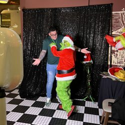 RoadGamers - Party Characters for your next event. Here we have the Grinch at a company holiday party acting mischievous as always!