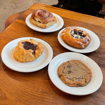 Grand Central Bakery - a man sitting at a table with a variety of pastries - Bakeries Near Me - Portland, Oregon Grand Central Bakery - a man sitting at a table with a variety of pastries - Bakeries Near Me - Portland, Oregon