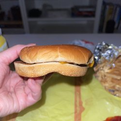 McDonald's - Squished cheeseburger with a hand print on top, per usual.