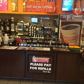 Dunkin' - a coffee shop counter with a sign that says please pay for refils - Donuts Near Me - Freehold, New Jersey Dunkin' - a coffee shop counter with a sign that says please pay for refils - Donuts Near Me - Freehold, New Jersey