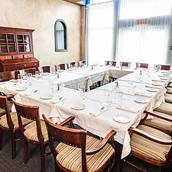 Restaurant Calvi - a long dining table set with place settings - Italian Near Me - Laval, Quebec Restaurant Calvi - a long dining table set with place settings - Italian Near Me - Laval, Quebec