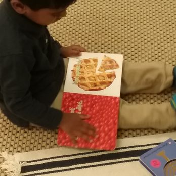 Cornus Montessori - Students learn to care for and respect books as they carefully turn pages without creasing or tearing. - Child Care & Day Care Near Me - Chantilly, Virginia