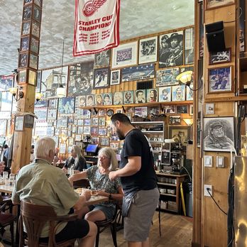 John's Place - interior of john's place with photos of sport teams, red wings stanley cup banner, celebrities, and caricatures - Breakfast & Brunch Near Me - Victoria, British Columbia