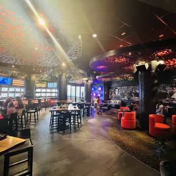 The Tuck Room - people sitting at tables and watching televisions - Cocktail Bars Near Me - North Miami Beach, Florida