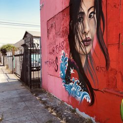 International Woman murals - Latina looking to her right at ?.