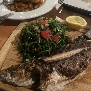 Selda Mediterranean - salmon in the back and Branzino w/ salad, was so fresh, simple and full of flavor. - Bars Near Me - Dallas, Texas Selda Mediterranean - salmon in the back and Branzino w/ salad, was so fresh, simple and full of flavor. - Bars Near Me - Dallas, Texas