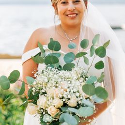 a bride holding a bouquet of flowers
