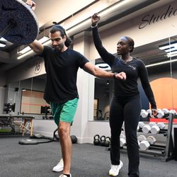 Studio 16 Personal Training - Studio 16 client performing a Landmine press