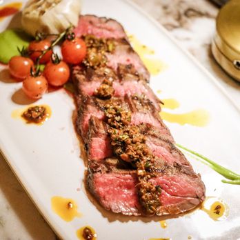 Predalina - Flank steak with green harissa and hearth roasted tomato. - Mediterranean Near Me - Tampa, Florida