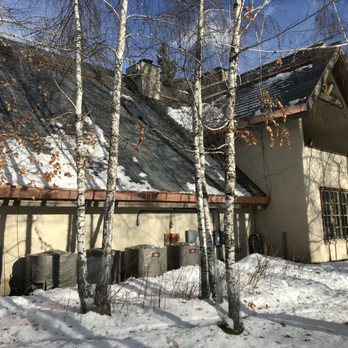 Dokime Construction LLC - a house in the snow - Roofing Near Me