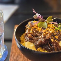 Tipsy Oyster Tapas and Bar - Indonesian coconut infused beef brisket served over a curry coconut rice and deliciously garnished with mayo "Last Joint"