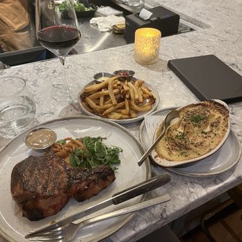 Juniper - Cider Braised Pork Chop, Au Gratin Potatoes, House Cut Fries - Cocktail Bars Near Me - Johnson City, Tennessee Juniper - Cider Braised Pork Chop, Au Gratin Potatoes, House Cut Fries - Cocktail Bars Near Me - Johnson City, Tennessee