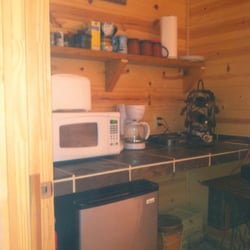 Chris's Cabin lodging - Kitchenette with fresh ground coffee, tea, and water    Microwave fridge toaster and coffee pot
