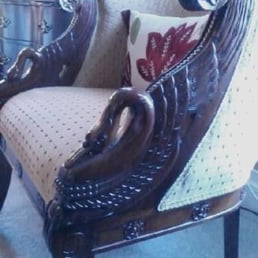 Pretty carvings of swans in wood armrests of chair in our room Pretty carvings of swans in wood armrests of chair in our room