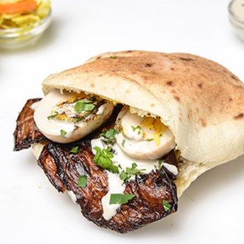 Sharonna’s Magically Baked Goods - Sabich is an Israeli sandwich based on a traditional Iraqi Jewish dish. It consists of pita stuffed with fried eggplant and hard boiled eggs - Bakeries Near Me - Canton, Massachusetts Sharonna’s Magically Baked Goods - Sabich is an Israeli sandwich based on a traditional Iraqi Jewish dish. It consists of pita stuffed with fried eggplant and hard boiled eggs - Bakeries Near Me - Canton, Massachusetts