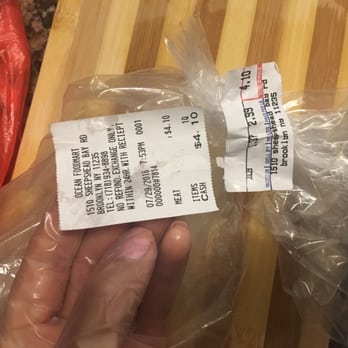 Ocean Foodmart - a hand holding a piece of food wrapped in plastic - Grocery Near Me - Brooklyn, New York Ocean Foodmart - a hand holding a piece of food wrapped in plastic - Grocery Near Me - Brooklyn, New York