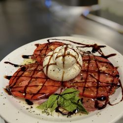Ambassador Restaurant - Burrata cheese platter. Prosciutto fresh tomato balsamic and truffle oil glaze.