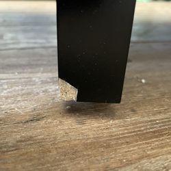 Indiana Furniture and Mattress - The laminate is popped off and it's clearly particle board underneath.