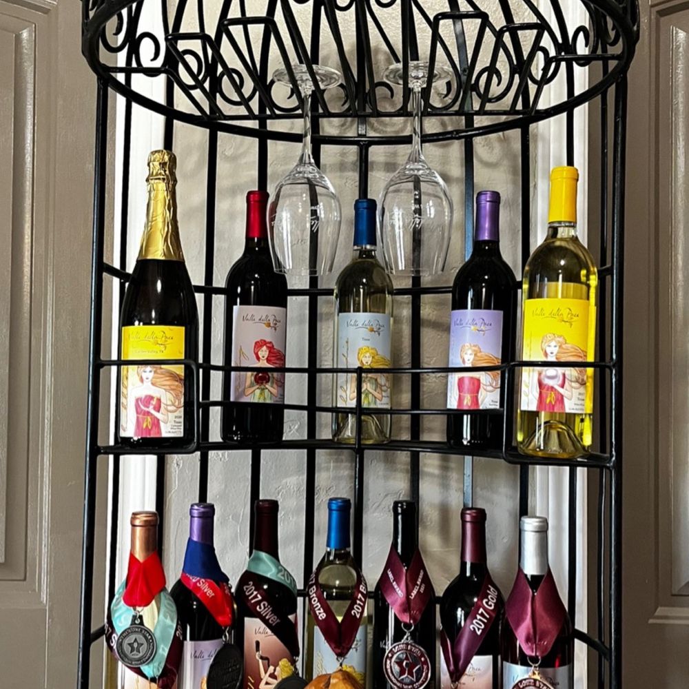 Valle Della Pace Vineyards & Winery - a wine rack with wine bottles and cheese - Wineries Near Me - Garden Valley, Texas Valle Della Pace Vineyards & Winery - a wine rack with wine bottles and cheese - Wineries Near Me - Garden Valley, Texas