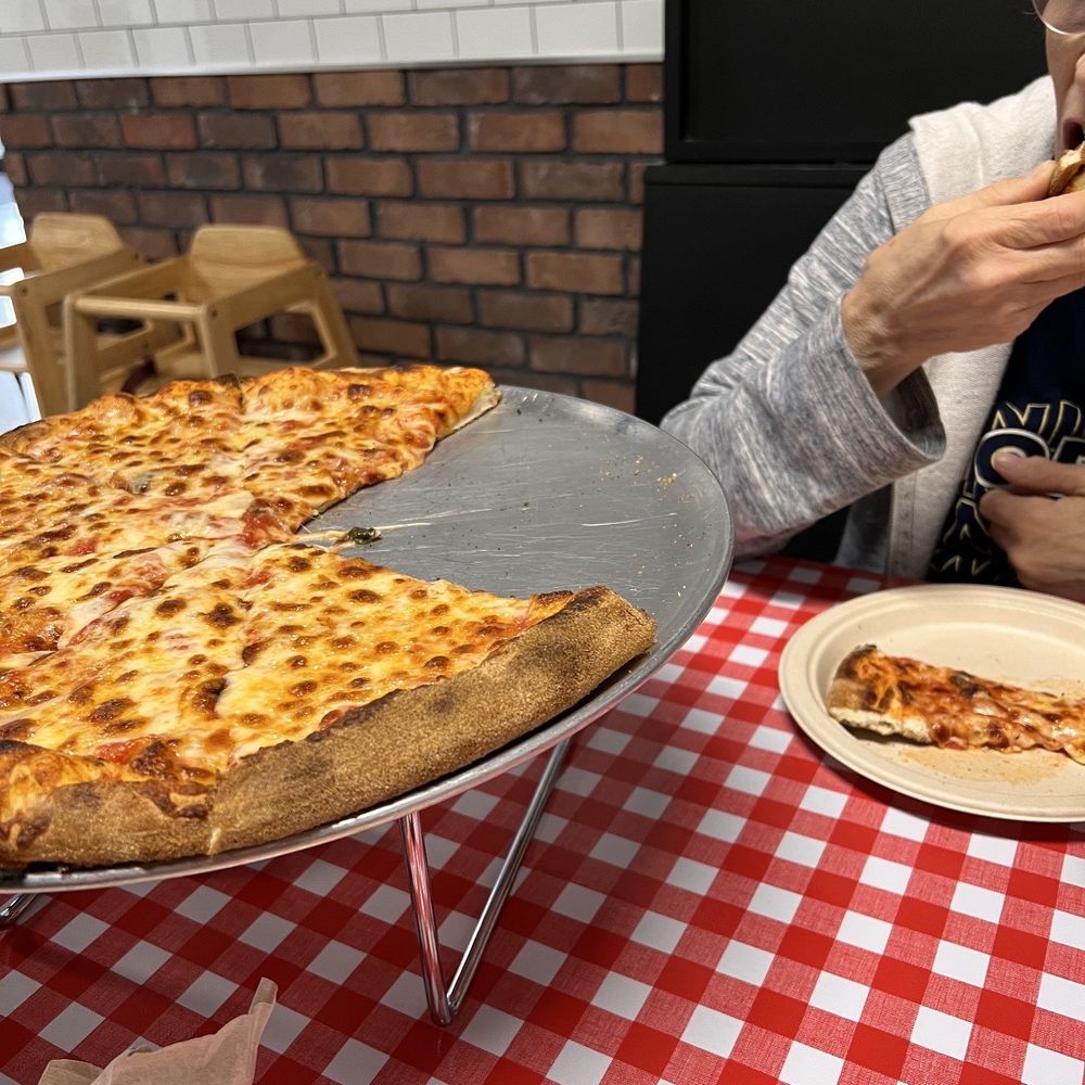 a woman eating a slice of pizza a woman eating a slice of pizza