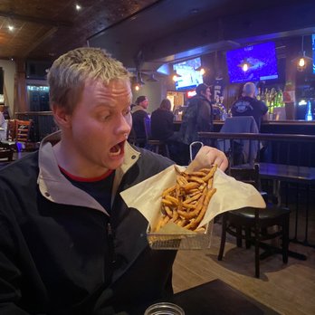 Chester's - a man eating french fries at a restaurant - American Near Me - Port Elgin, Ontario