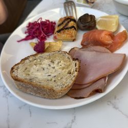Citrique - Sourdough toast, smoked ham and smoked salmon with a mushroom and a cheese roll with vegamite on top and pickled red cabbage.